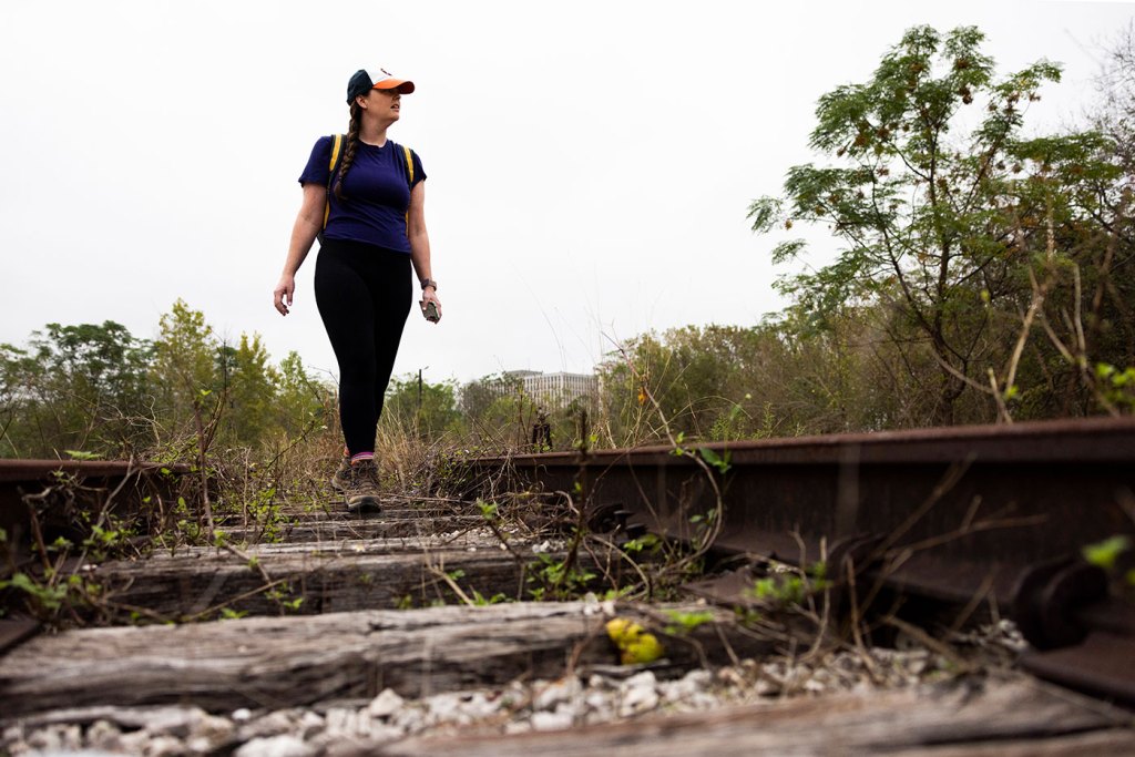 Houston Landing columnist Maggie Gordon walks along an abandoned railroad tracks in Houston, Texas