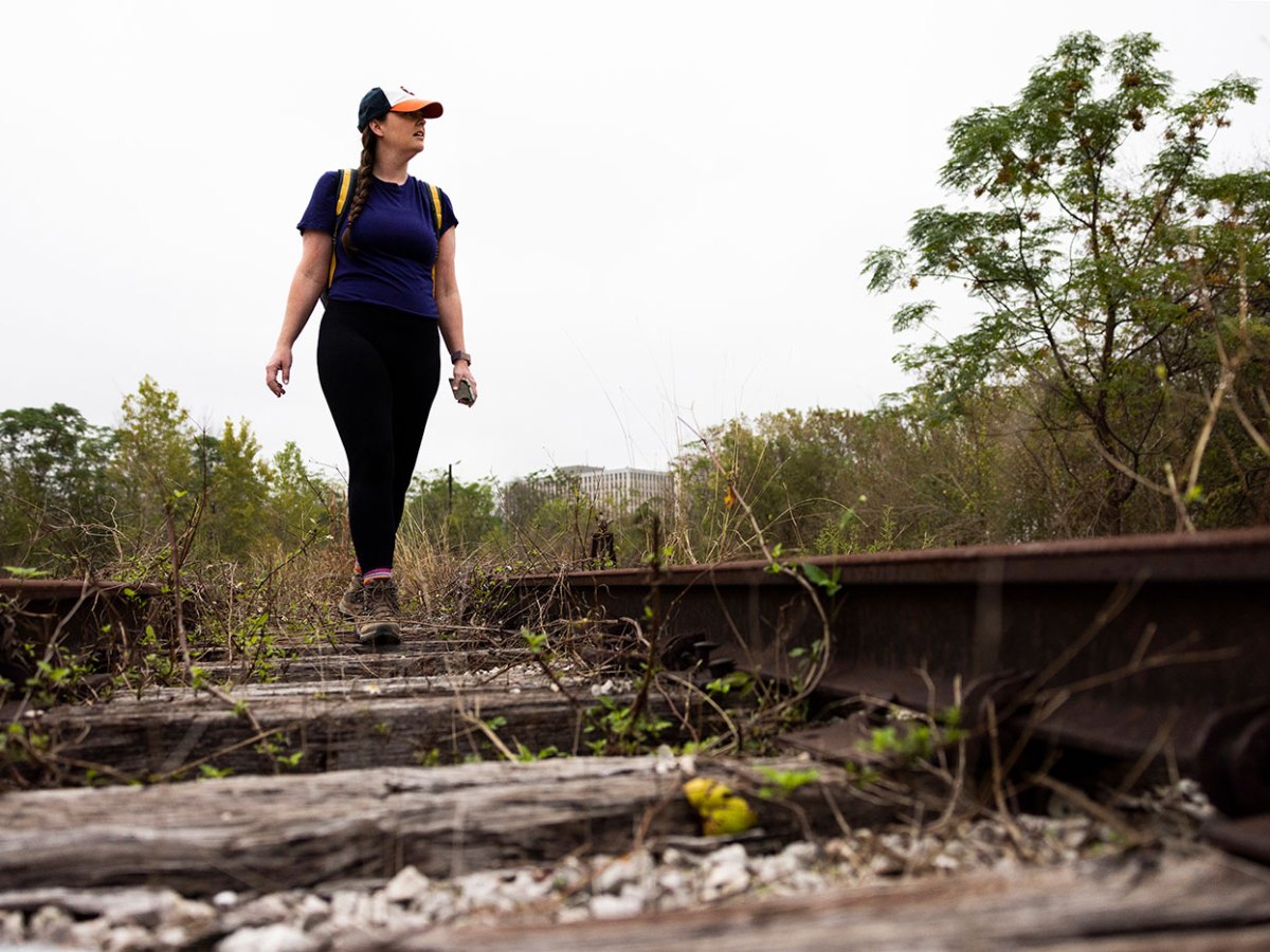 Houston Landing columnist Maggie Gordon walks along an abandoned railroad tracks in Houston, Texas