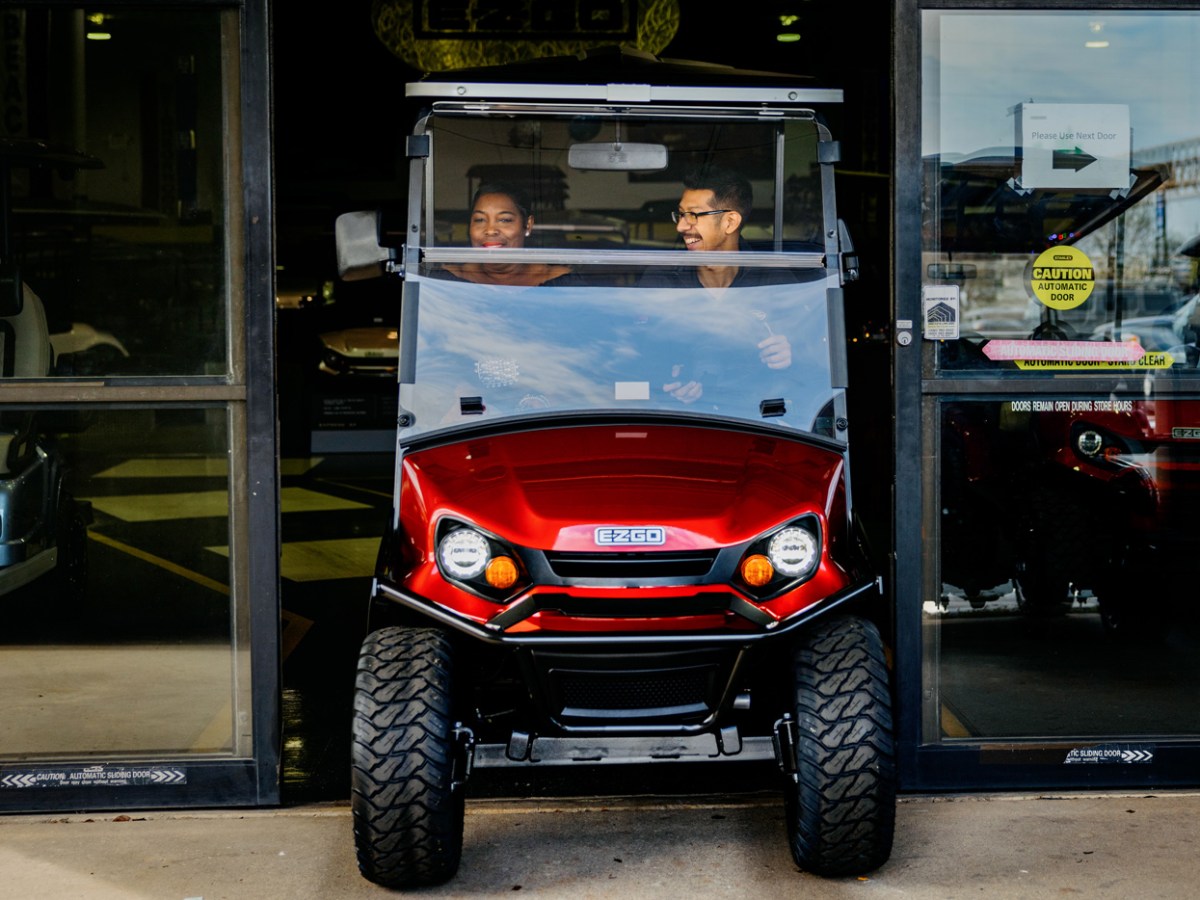 Tracy Curtis, left, rides a golf cart with Golf Cars of Houston Superstore sales consultant Abel Barrera as she shops for one to be used by her family