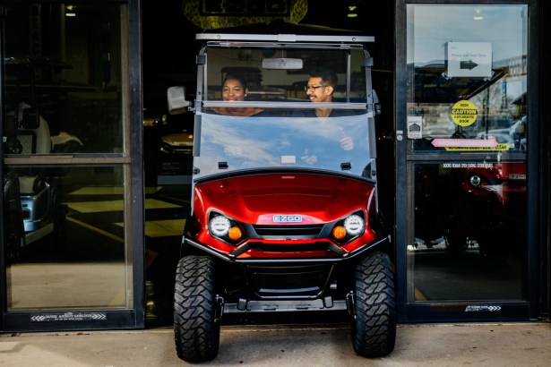 Tracy Curtis, left, rides a golf cart with Golf Cars of Houston Superstore sales consultant Abel Barrera as she shops for one to be used by her family