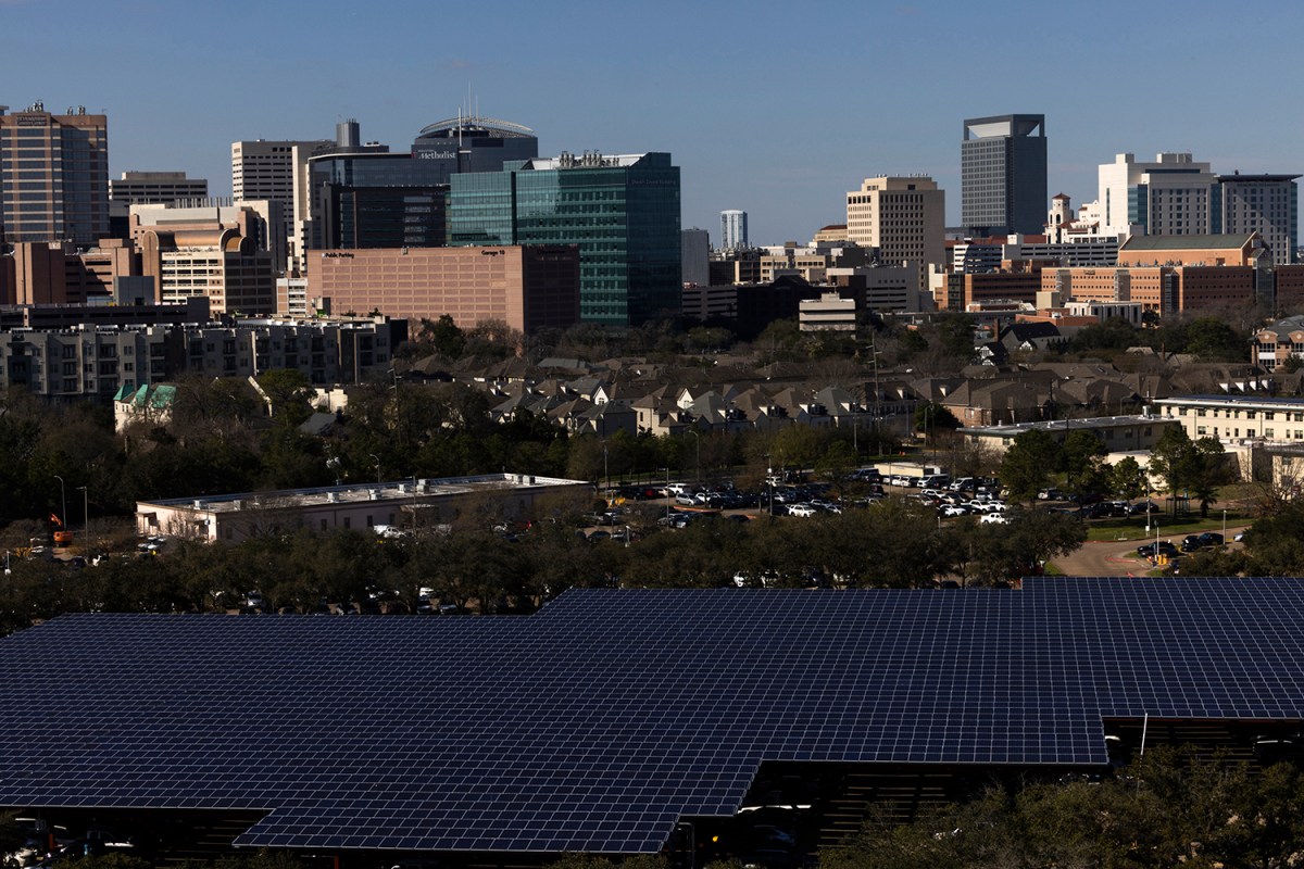 View of solar panels covering the parking lot of the Houston VA hospital campus with the view of the Texas Medical Center on the background.
