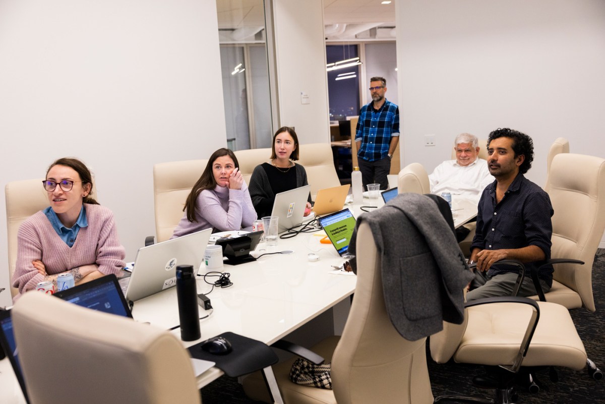 The Houston Landing team gathers around a conference room table the night before their website launched on Feb. 1, 2023, in Houston.