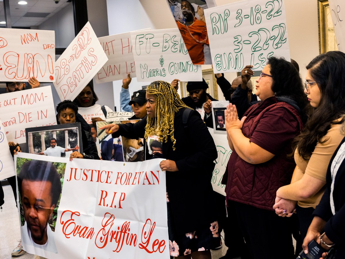 Holding a photo of her son Evan Lee, who died in Harris County Jail in 2022, Jacilet Griffin-Lee talks to the media after speaking to members of the Texas Commission on Jail Standards.