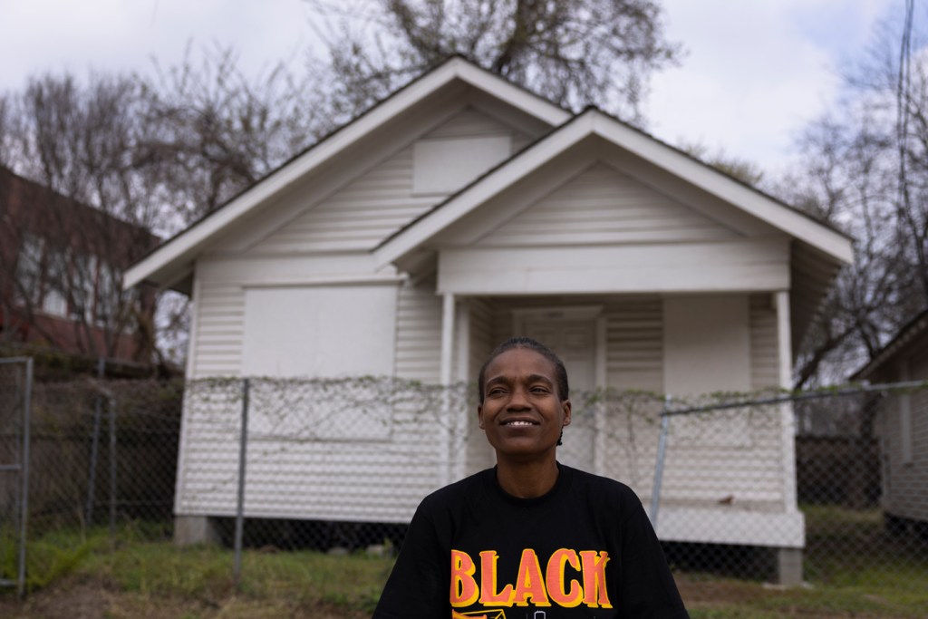 Charonda Johnson, vice president of the Freedmen’s Town Association, stands in front of her childhood home while giving a tour of Freedmen's Town on Feb. 23, 2023, in Houston.