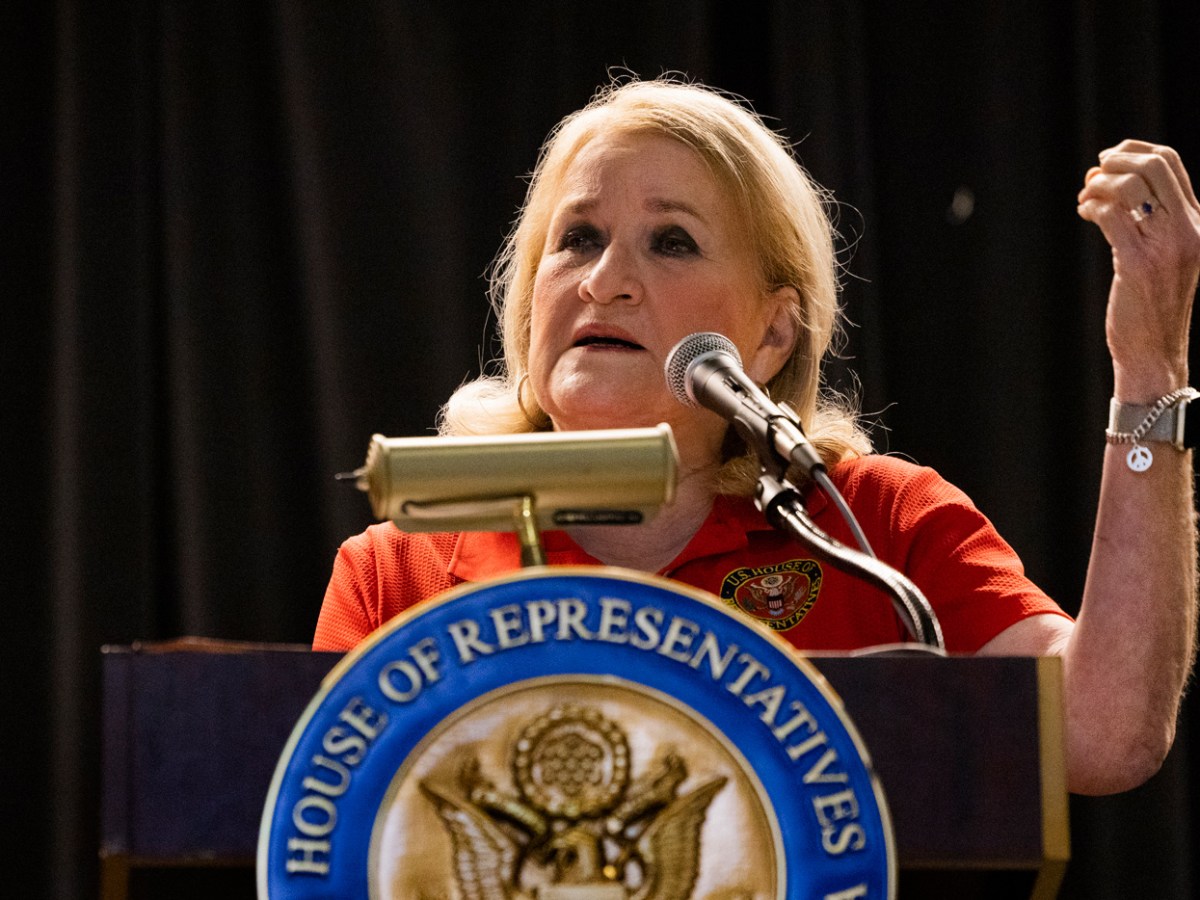 Congresswoman gives a speech behind a podium