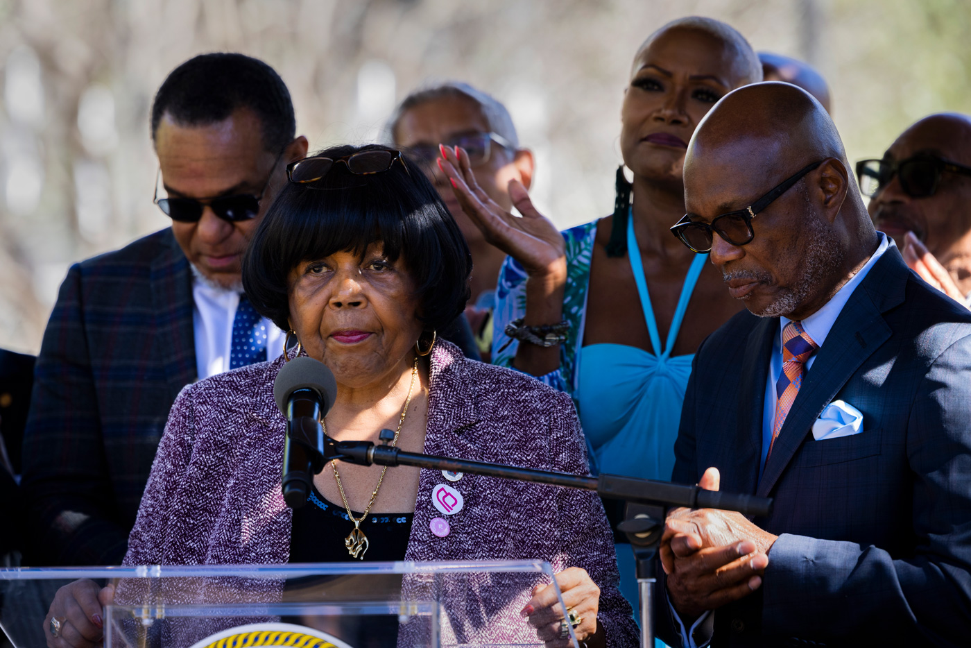 State Representative Alma Allen stands behind a podium speaking at a protest in Houston