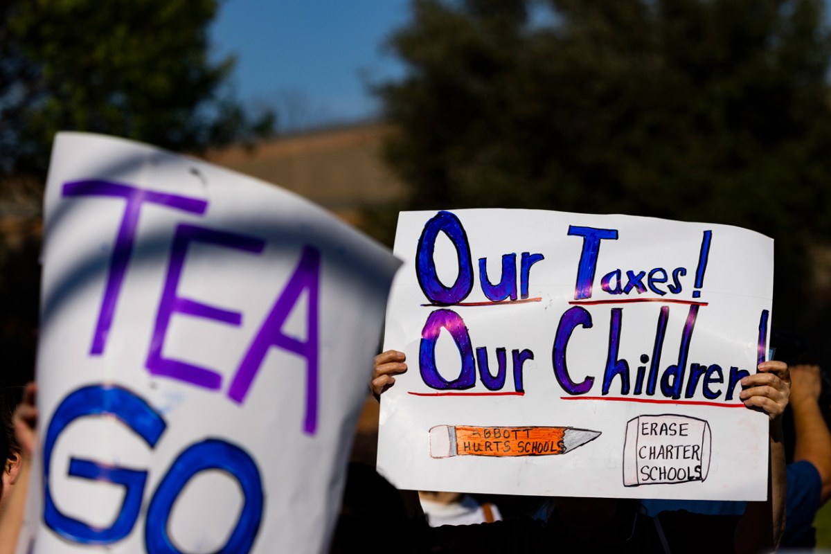 Parents of Houston ISD students hold signs demonstrating their opposition to the Texas Education Agency replacing the district's school board and superintendent during a March 14 protest at Wheatley High School in Houston's Greater Fifth Ward. (Houston Landing file photo / Marie De Jesús)