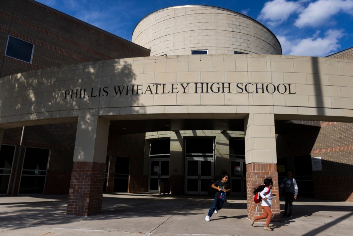 Children play around the entrance of a school.