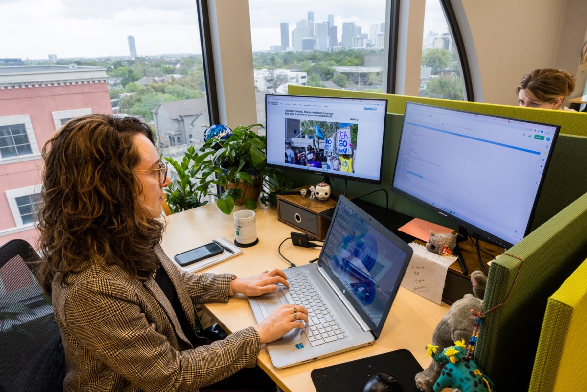 Reporter works from a newsroom.