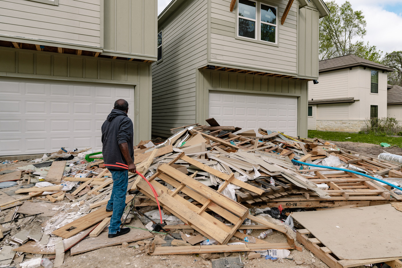 Construction trash in front of new homes