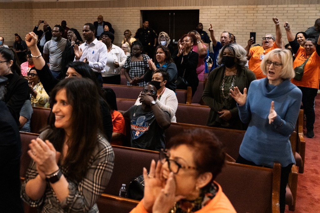A group of people cheer in support of the Houston Independent School District as the Texas Education Agency prepares to oust HISD's board.