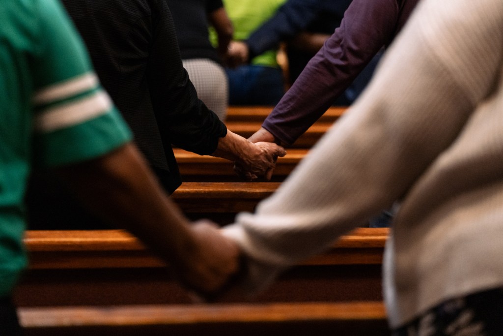 People hold hands as they protest a looming TEA takeover of the Houston Independent School District.