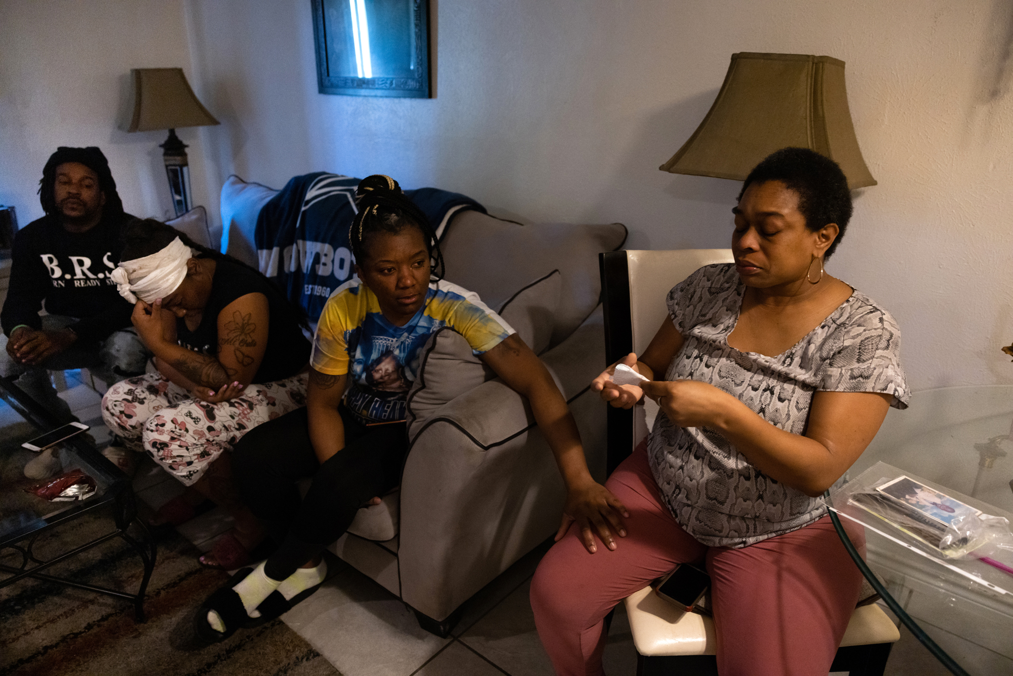 A family gathers in a livingroom
