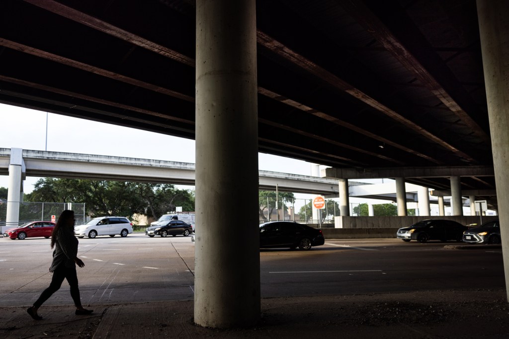 Woman walks under an overpass
