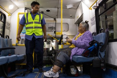 Joseph Coleman, at left, checks in on Shari Quattlebaum before starting the METROLift ride outside of Metropolitan Multi-Service Center in Houston.
