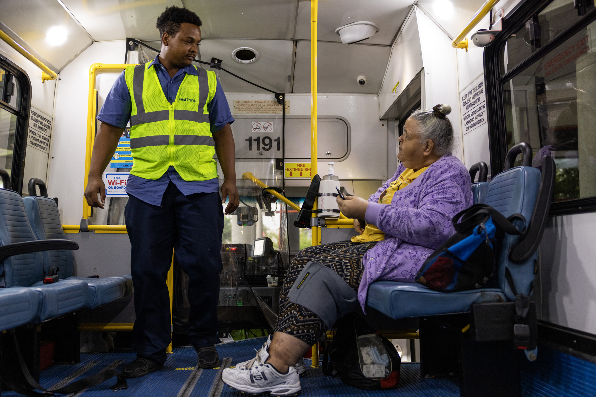 Joseph Coleman, at left, checks in on Shari Quattlebaum before starting the METROLift ride outside of Metropolitan Multi-Service Center in Houston.