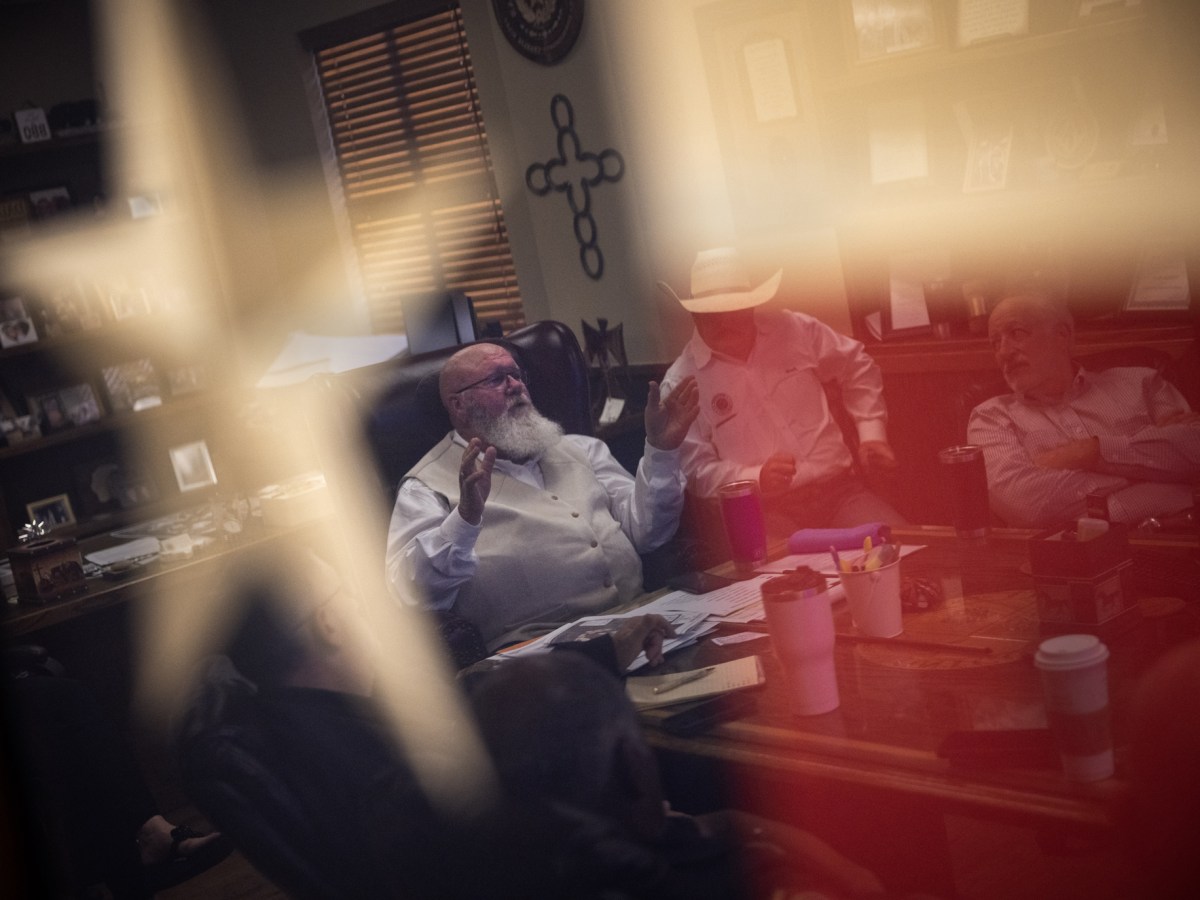 Reflection of a man through Texas flag