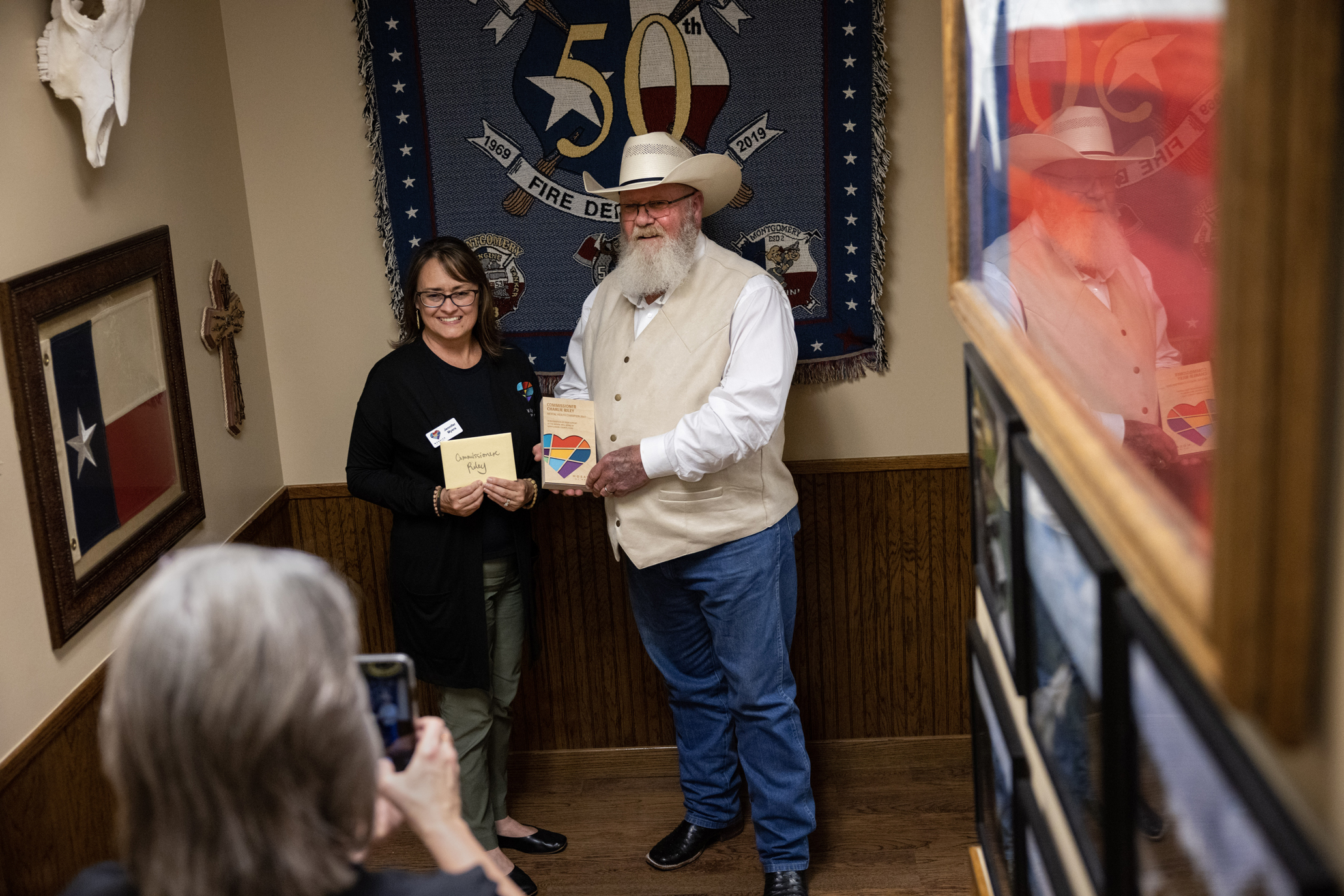 Two people have their photo taken at a government agency.