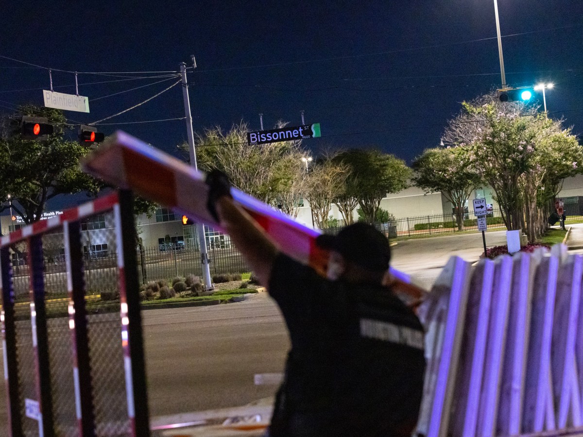 A police officer places barricades