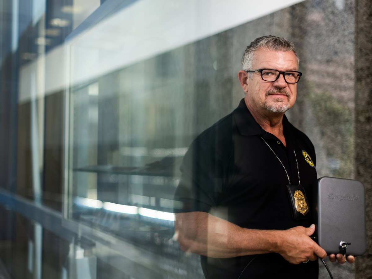 Houston police officer Tracy Hicks holds a gun lock box