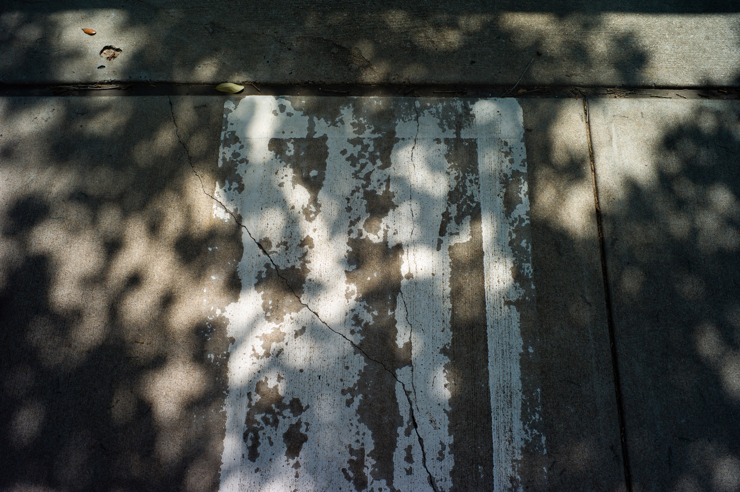 Photo of the road with worn out road stripes making it hard to see the road stripes