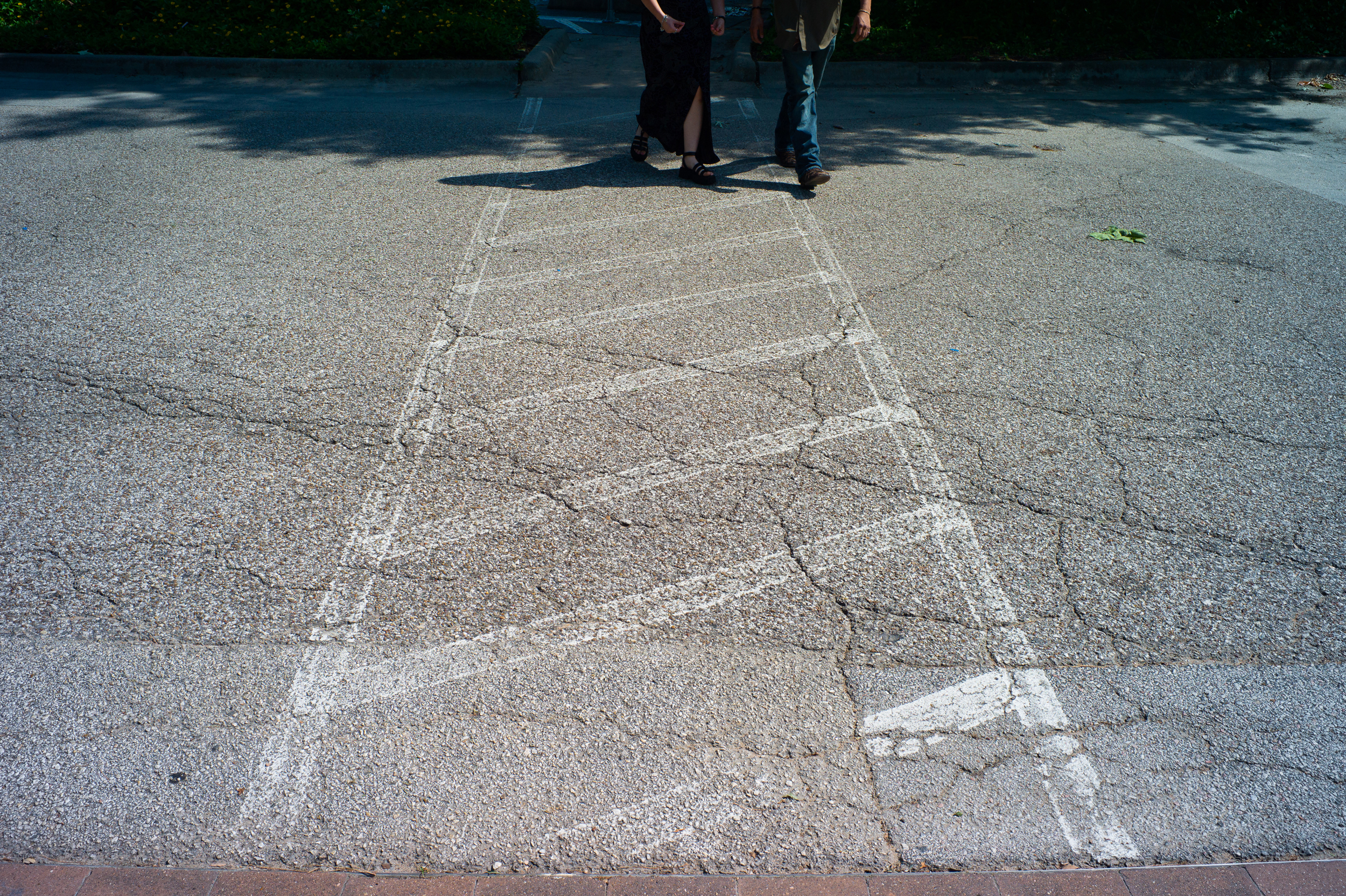 Photo of the road with worn out road stripes making it hard to see the road stripes