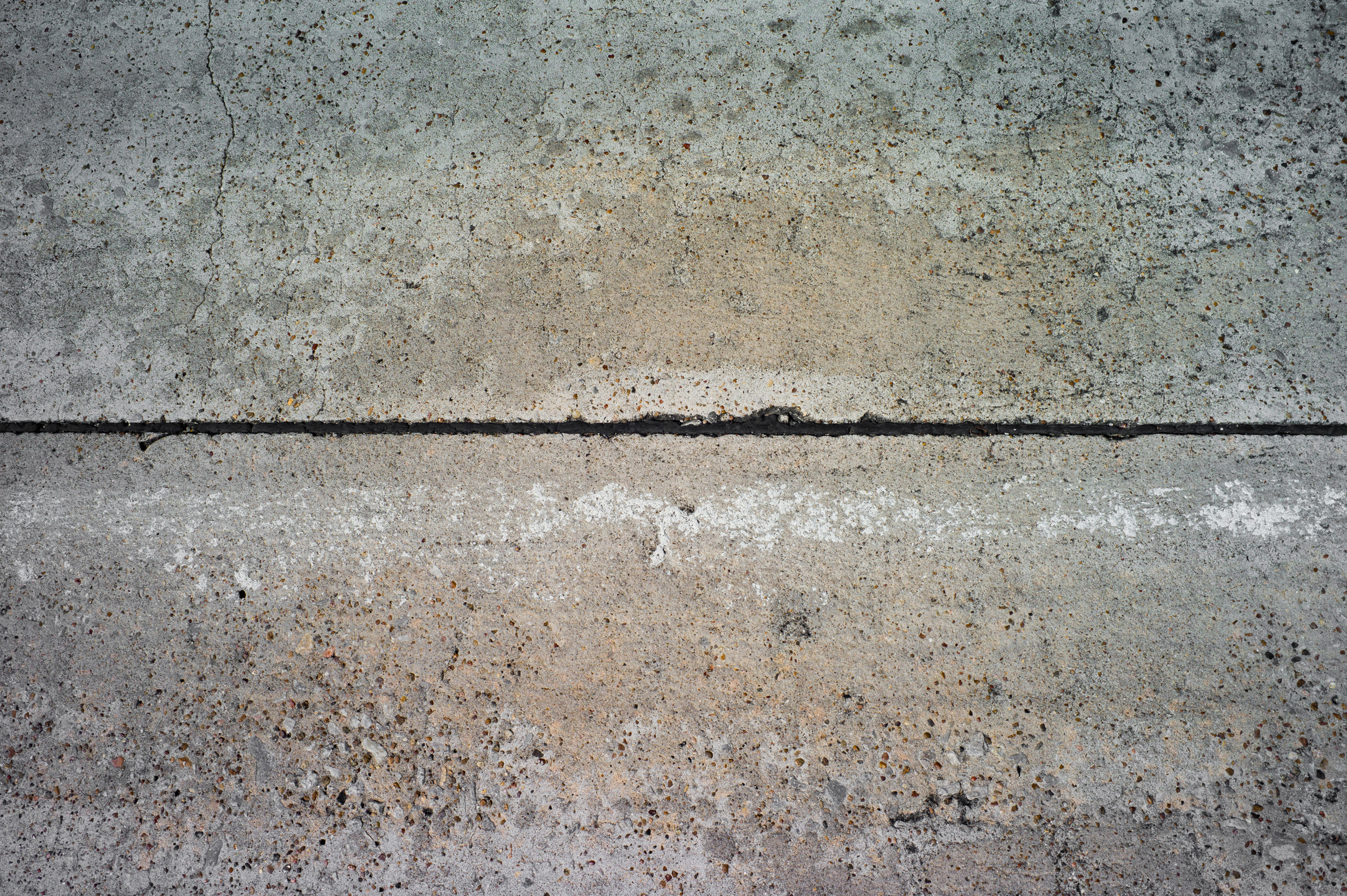 Photo of the road with worn out road stripes making it hard to see the road stripes