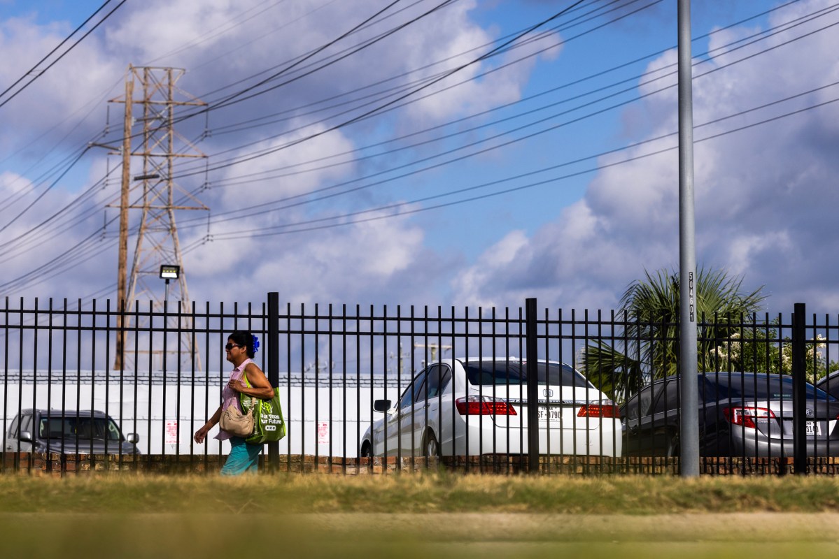 A woman walks on Chimney Rock Road in Houston