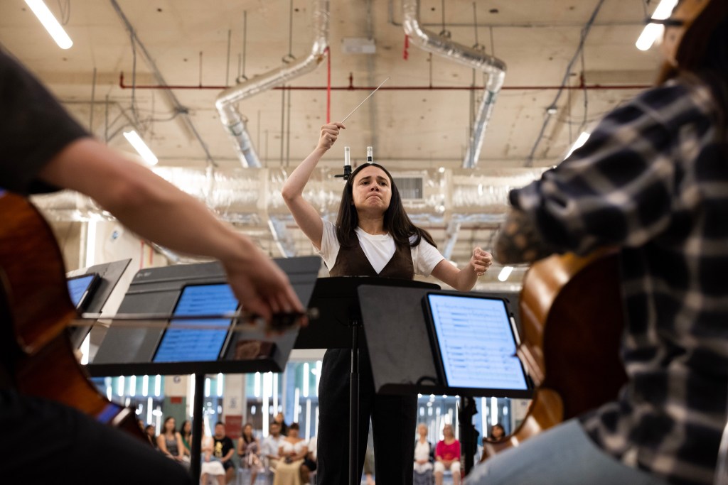 Maura Tuffy, maestro, leads musicians during a performance at The Post
