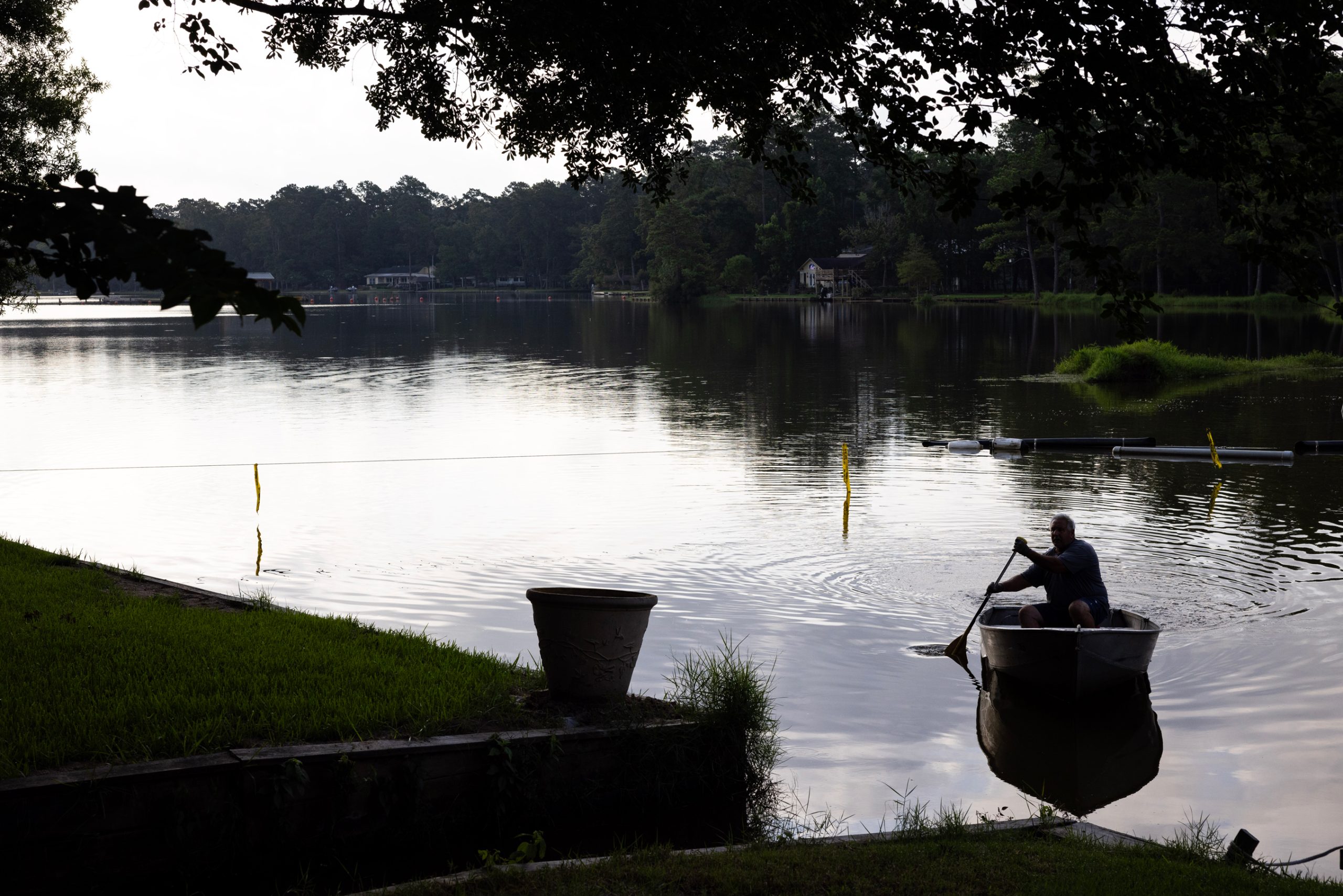 Kevin Hennis paddles his boat back to shore at Lake Forest Falls