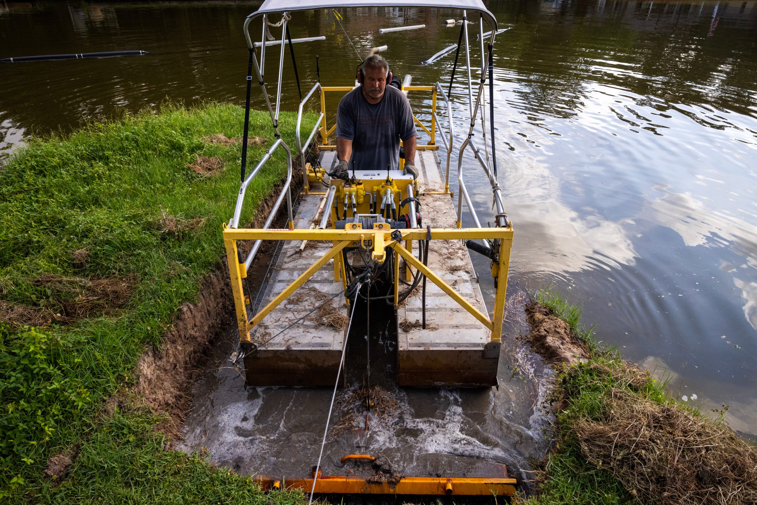 Kevin Hennis spends the morning dredging slit in a segment of Lake Forest Falls