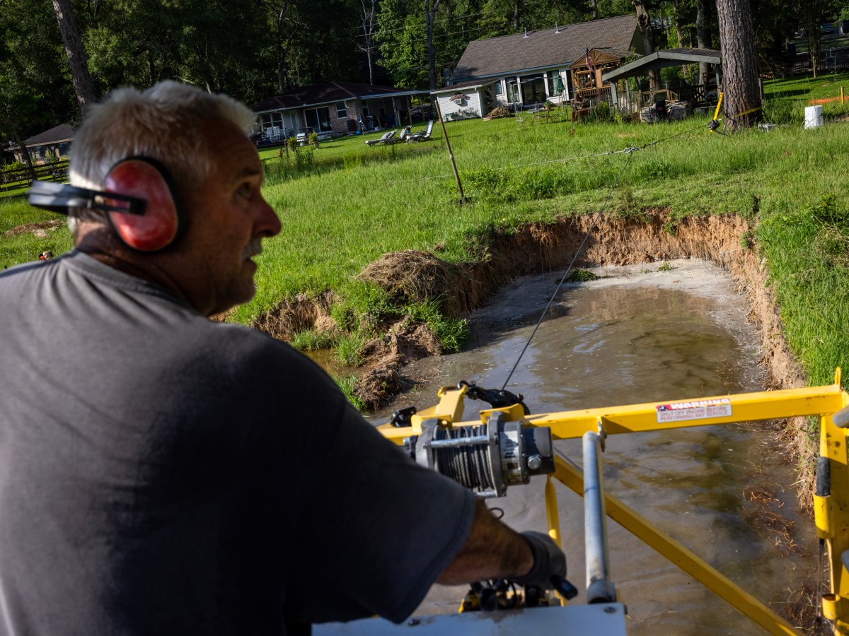 Kevin Hennis spends the morning dredging out silt in a segment of Lake Forest Falls