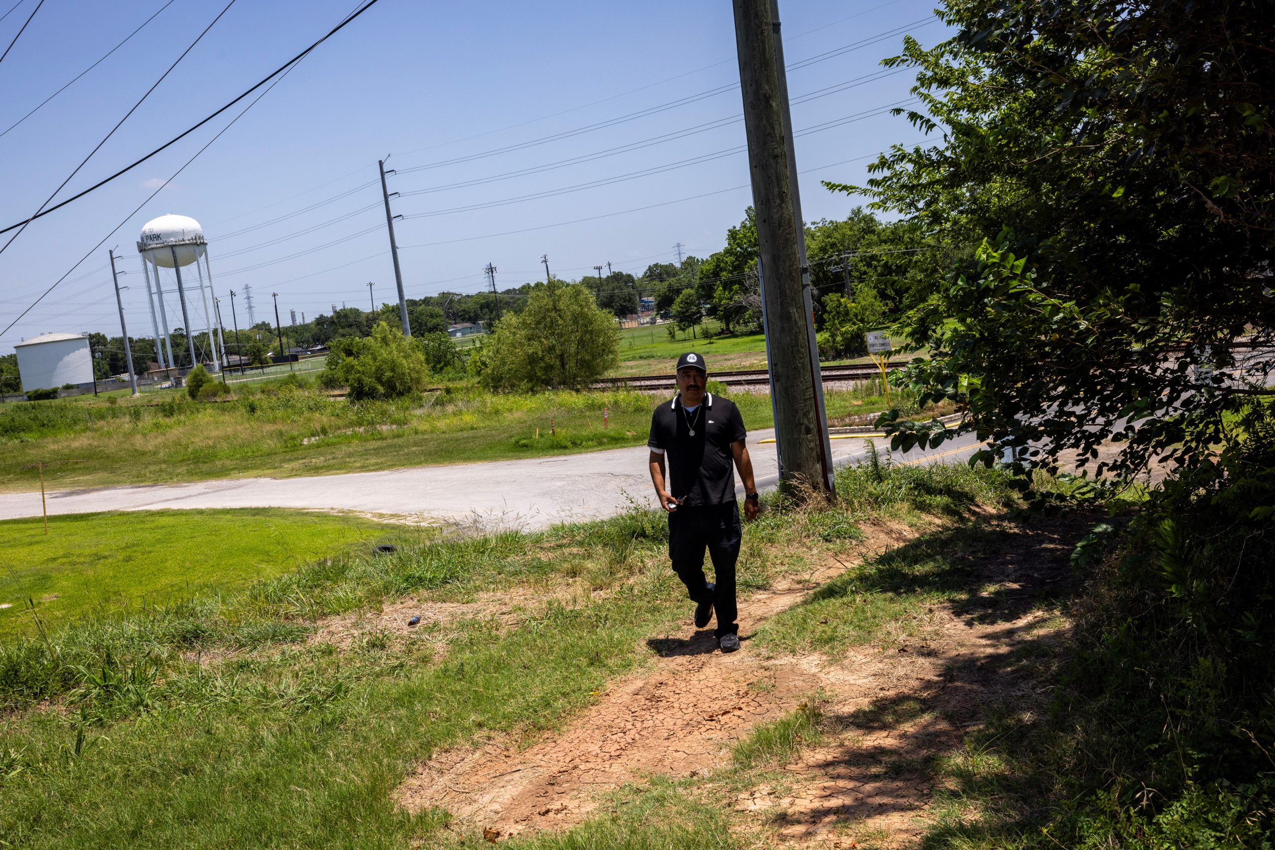 Juan Flores, Community Air Monitoring Program Manager for Air Alliance Houston, walks up to a dredging site