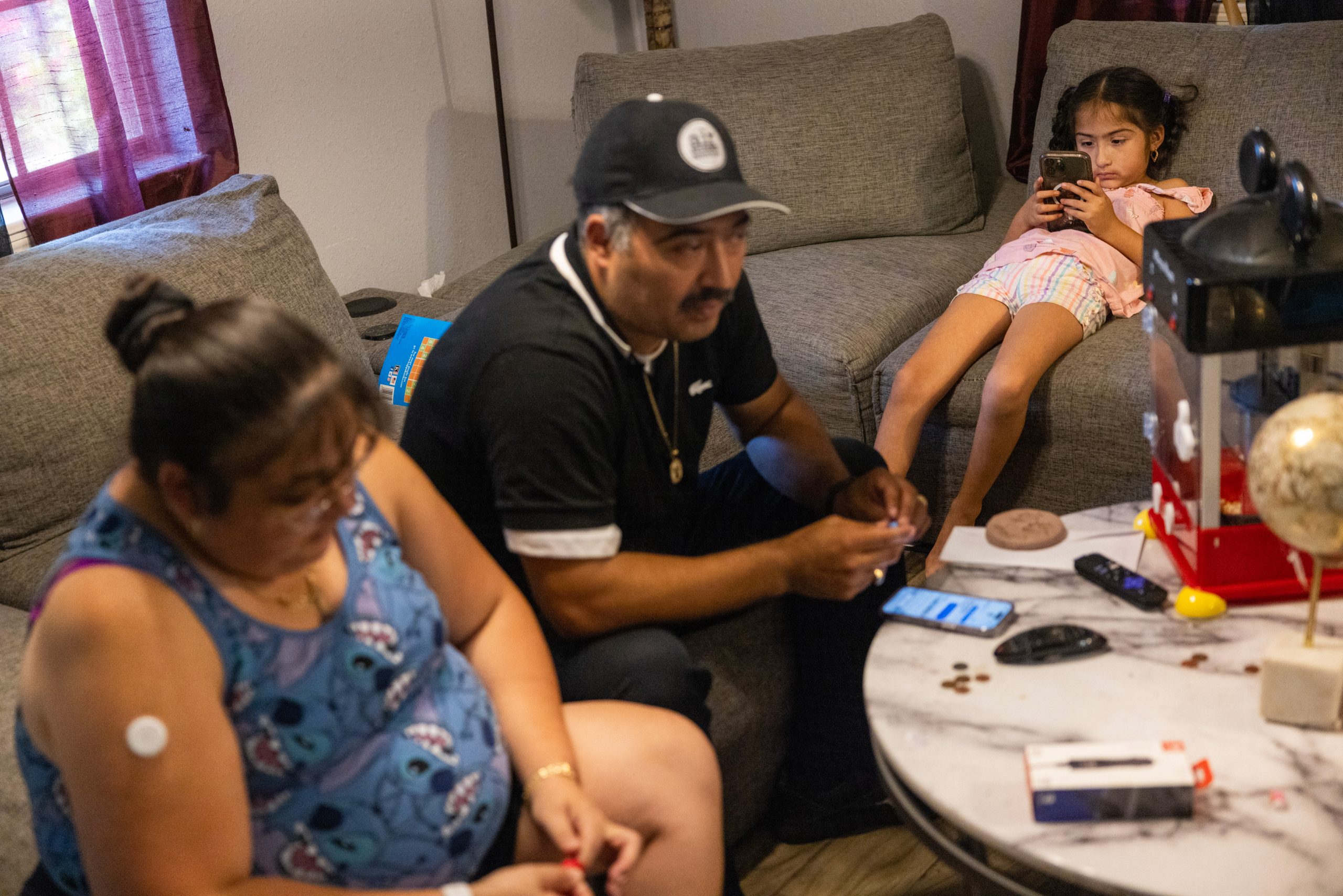 Dominique Flores Barraza, 7, plays on her phone