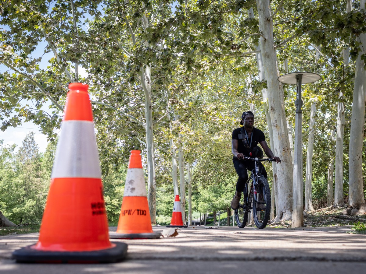 A bicyclist turns around at a closed section of Buffalo Bayou Park trail in Houston