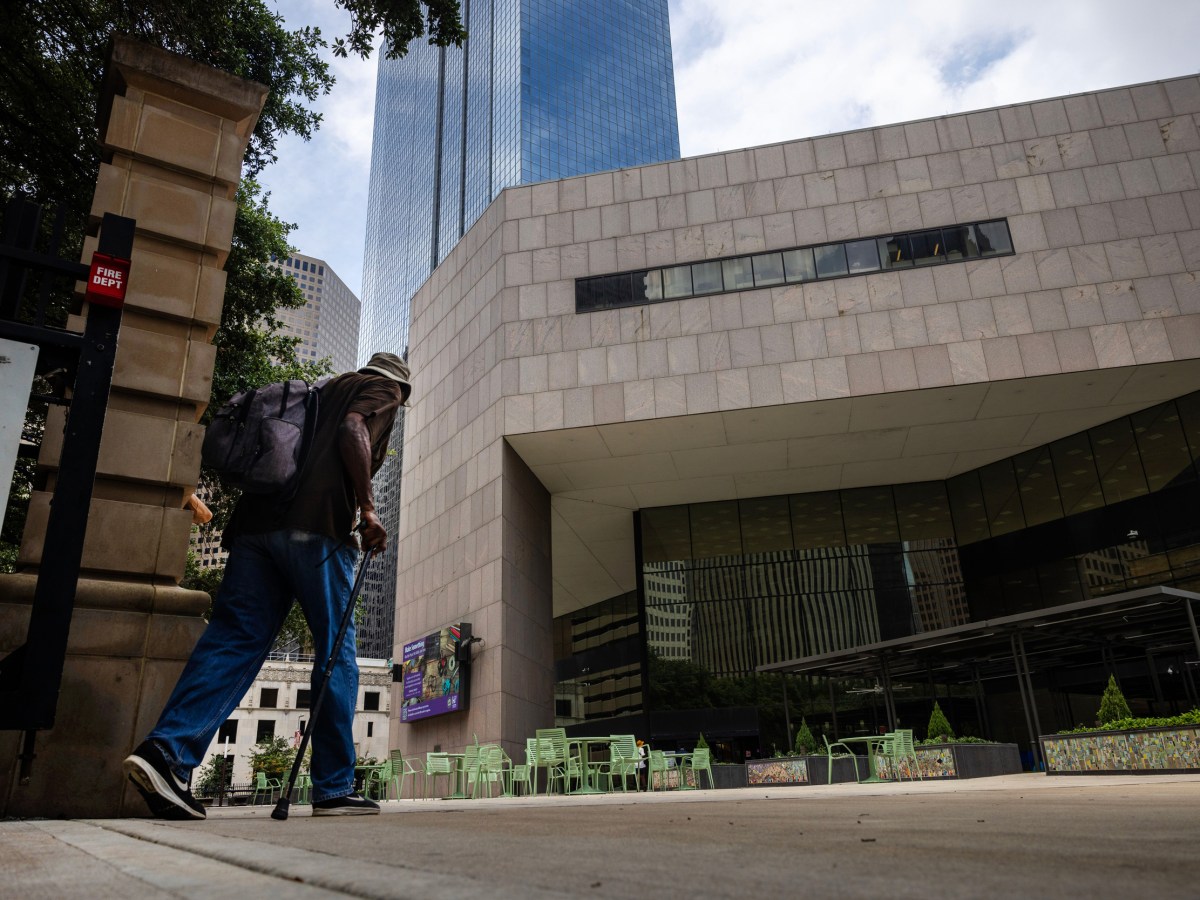 A man walks toward the entrance to the Houston's central library.