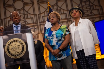 Mayor Sylvester Turner gives opening remarks Thursday while accompanied by Fifth Ward residents Joetta Stevenson, at center, and Pamela Matthews, at right