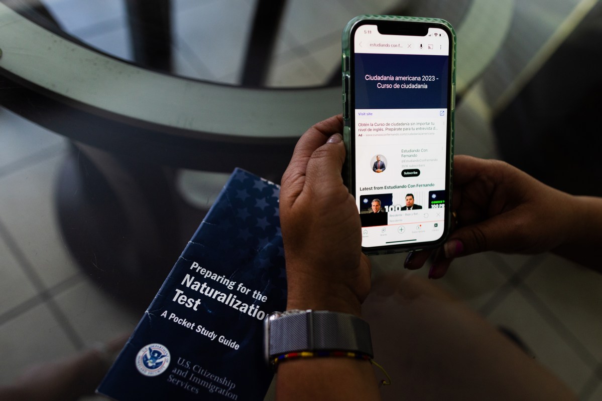 Jessica Mejia Ramirez shows in her smartphone a course in Spanish she uses to study for the U.S. naturalization tes