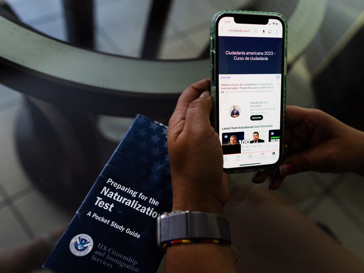 Jessica Mejia Ramirez shows in her smartphone a course in Spanish she uses to study for the U.S. naturalization tes