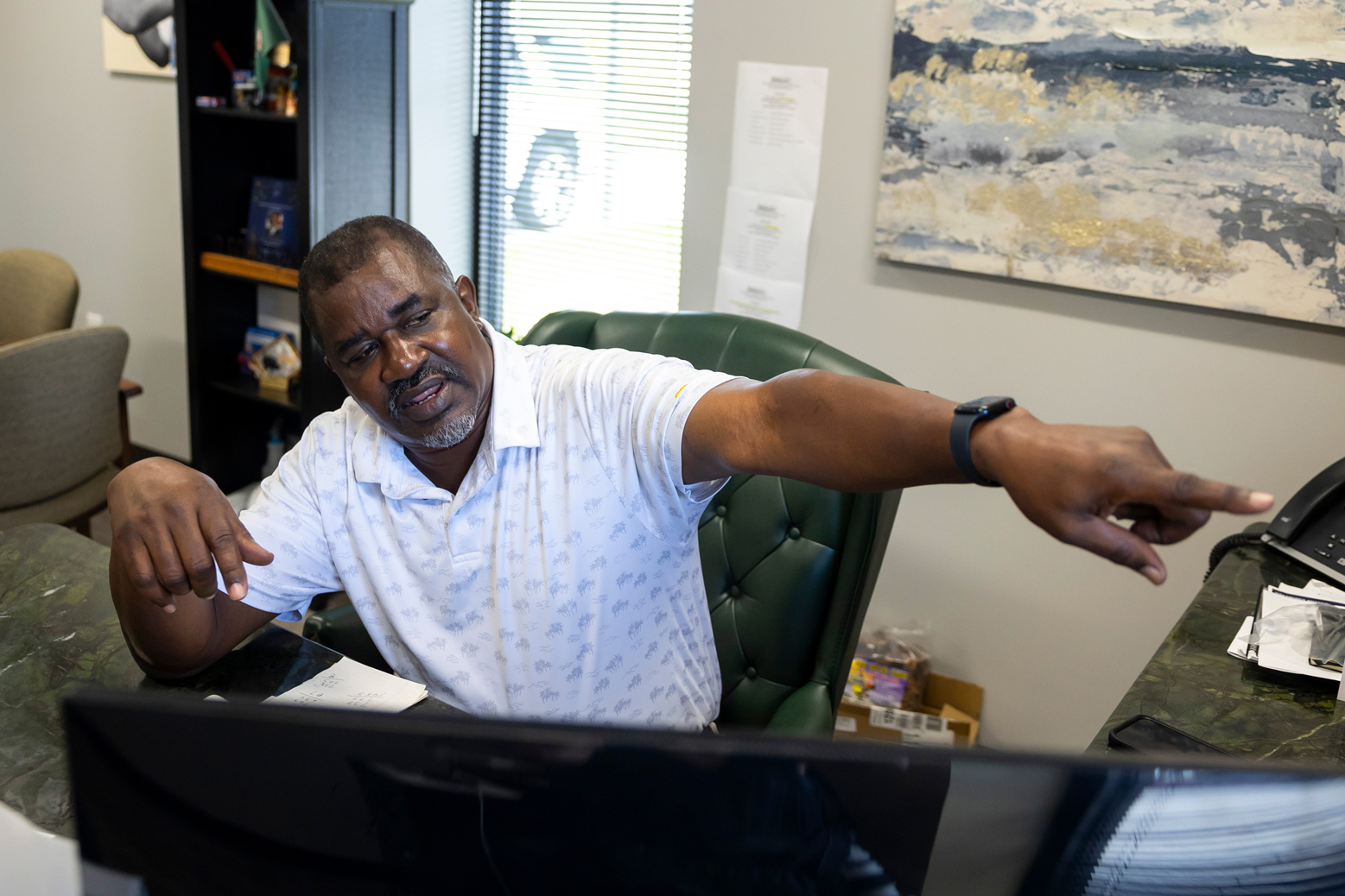 City of Arcola Mayor Fred Burton points to different acres of land he has tried to acquire in hopes of building recreational structures for his residents in his office at city hall on Tuesday, July 18, 2023. (Annie Mulligan for Houston Landing)