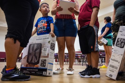 David Ramos, 5, holds a fan donated to his family