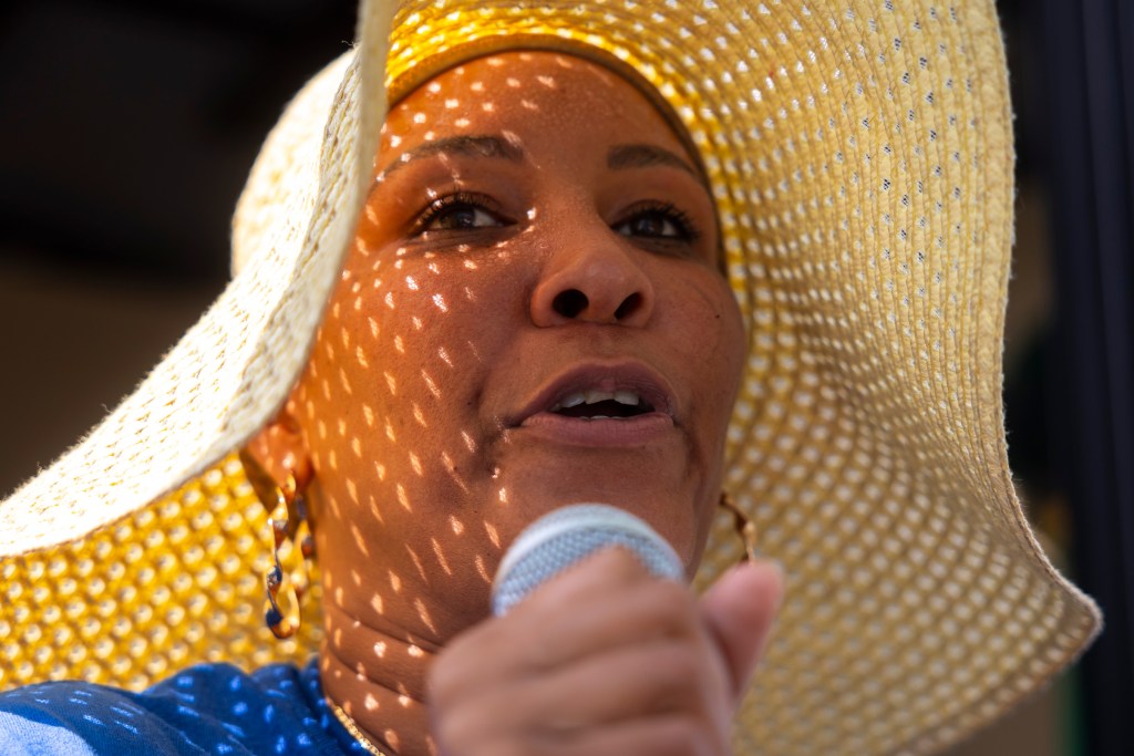 Urban Harvest staff member Felecia Thomas gets on the mic to bring costumers to a farmers market