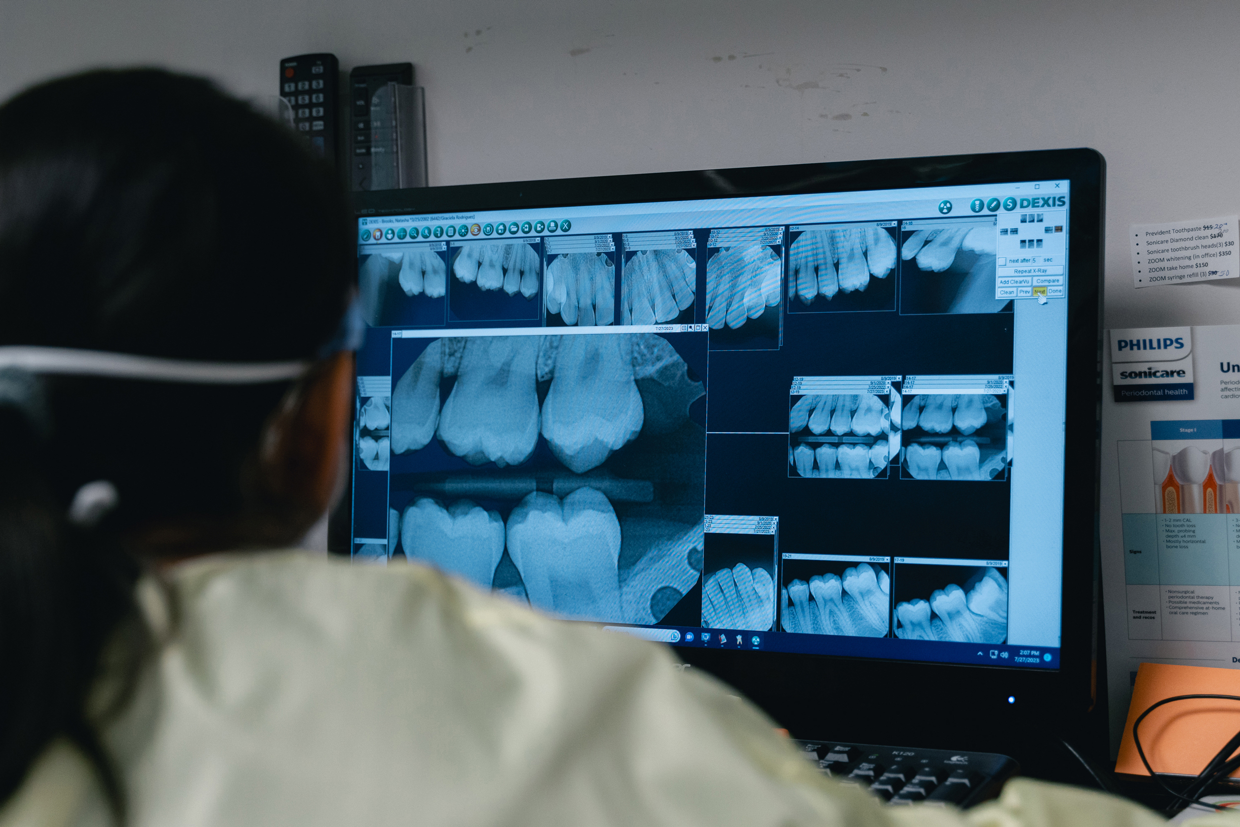 Dr. Grace Rodriguez examines a patient’s teeth x-rays.