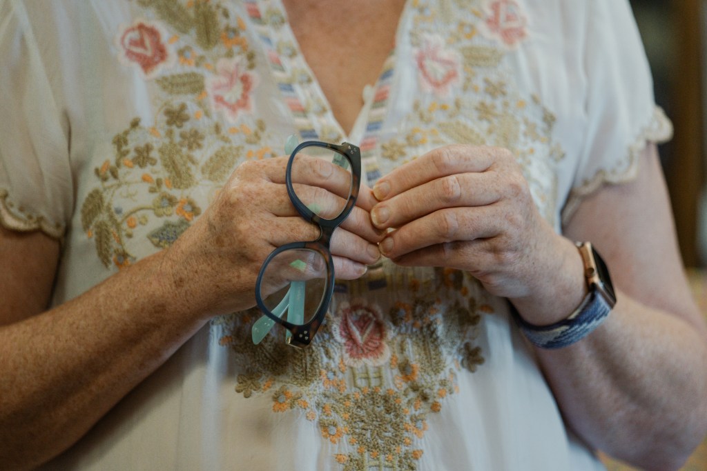 Valerie Koehler, owner of Blue Willow Bookshop, holds her glasses