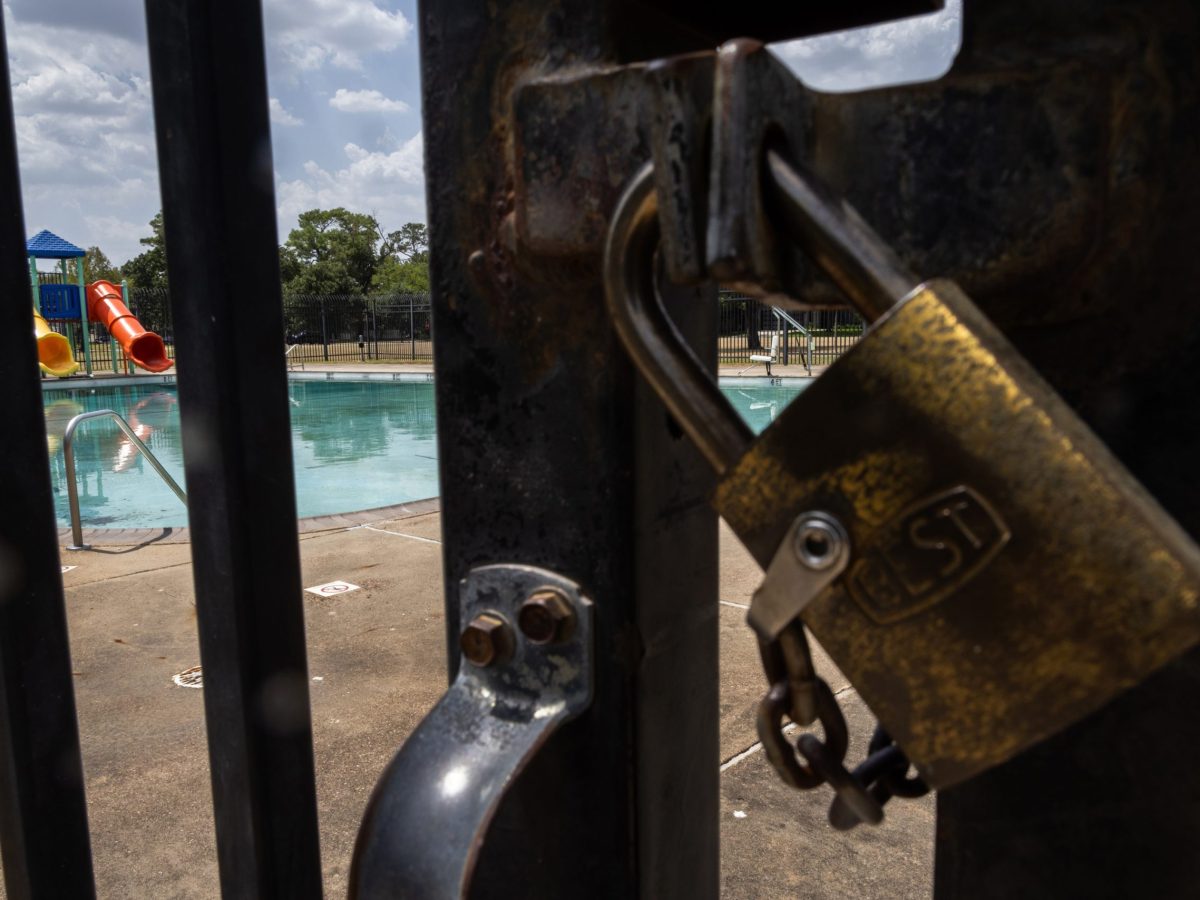 A lock keeps the gates of the Oak Forest swimming pool closed to the public, Friday, July 28, 2023, in Houston.
