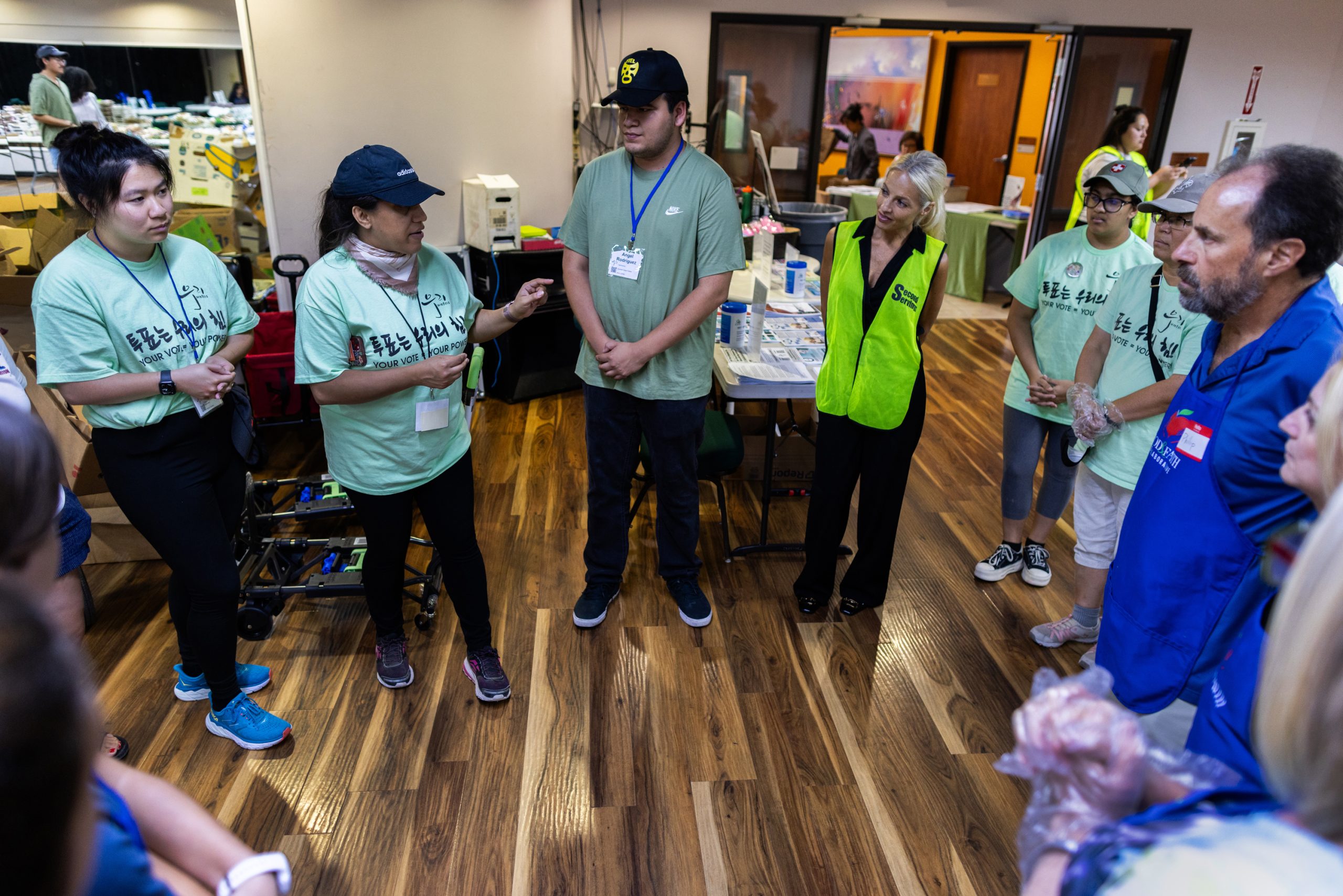 Woori Juntos, Second Serving and Food & Faith Collaborative team members gather to talk about logistics