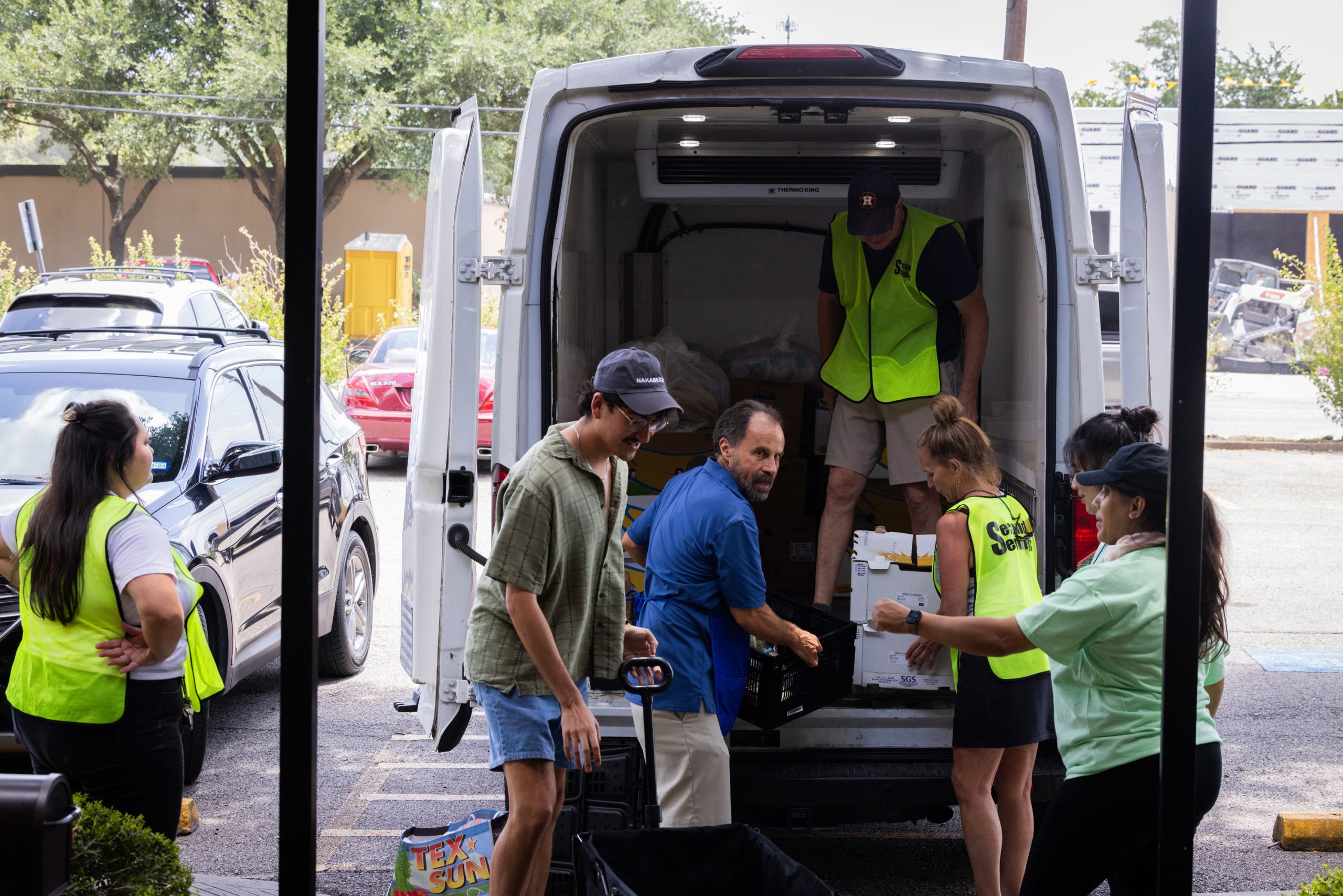 Volunteers provide support to the Second Serving team members by carrying boxes with edible surplus food 