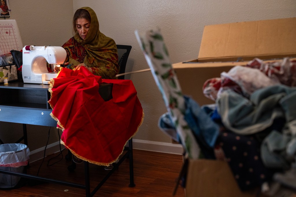 Shukria Barlas sews a children's dress during a sewing class for women