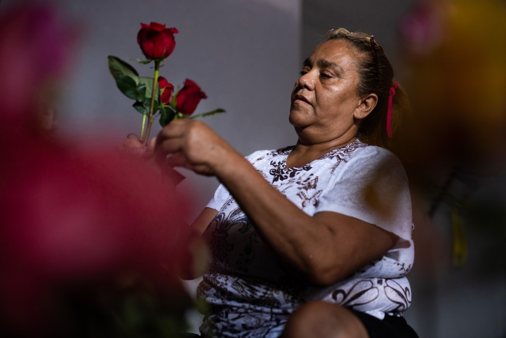 Beatriz Meraz Vargaz makes flower arrangements in her hot apartment