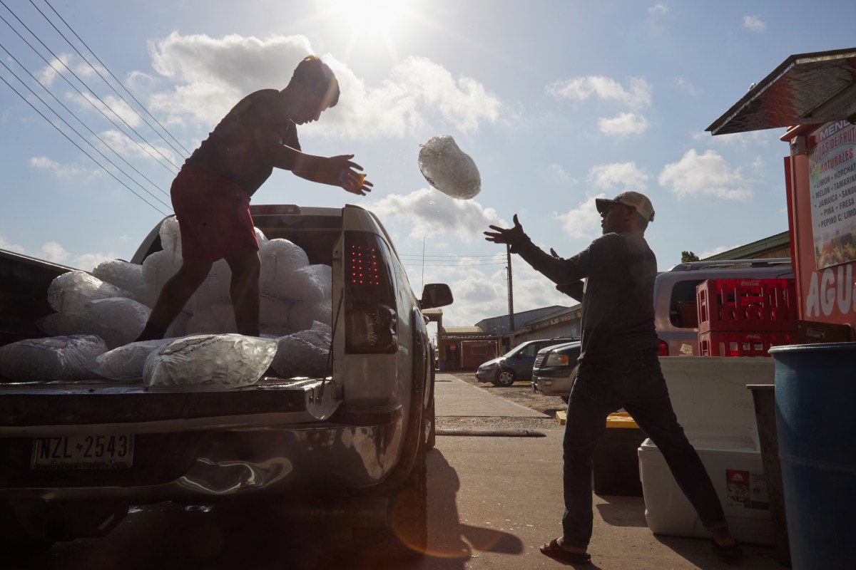 Two men deliver ice to vendors throughout Sunny’s Flea Market